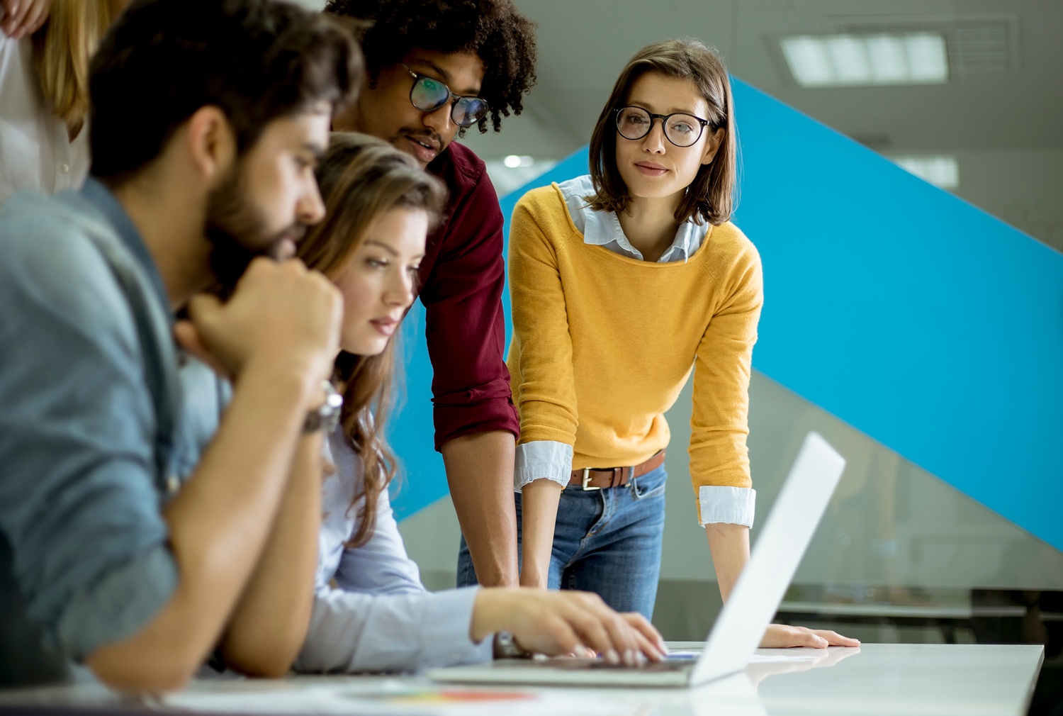 QA with Michael Crawford America Succeeds_feature: group of young office workers working together on laptop at table