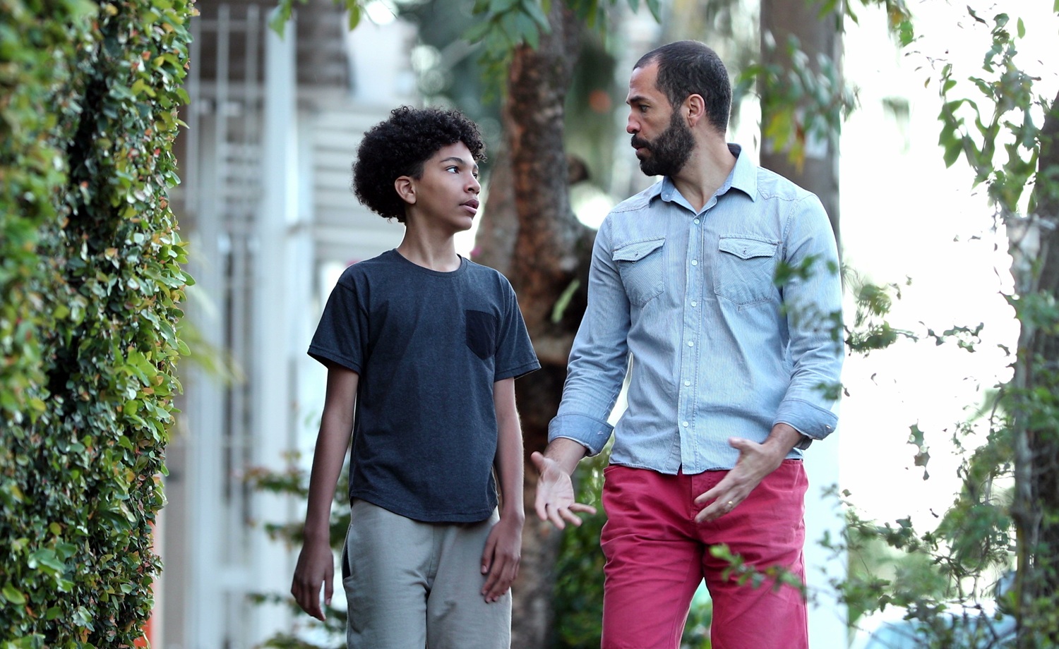A capstone essay on 50 years of promoting positive youth development _feature: young boy and mentor/father figure walk outdoors while talking