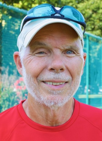 Peter C Scales headshot: older white man with baseball hat and sunglasses on top of hat in red shirt outdoors