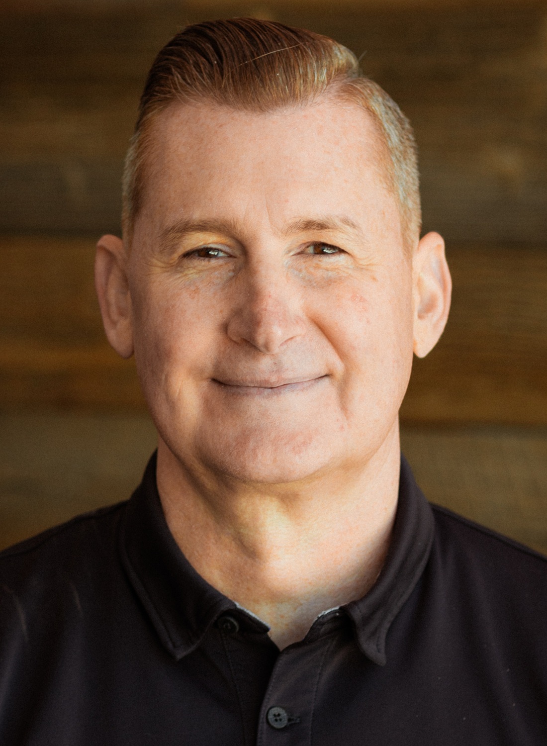 Bill Bedrossian headshot, youth homelessness : white man with short hair wearing black polo