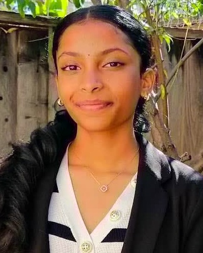 Mahi Mekala headshot: young woman with long dark hair outside