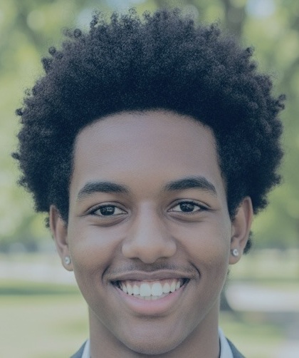 Amanuel Asfaw headshot, Minnesota ICE operation: black male teenager with afro style hair smiling outdoors