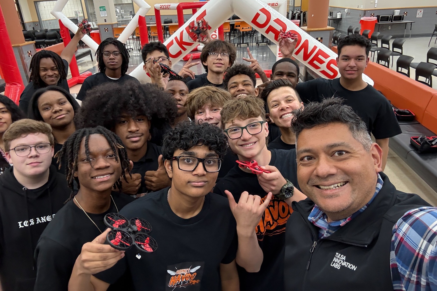 Giving Tulsa students a clear path from curiosity to career_feature, afterschool STEM: group of youths in rocket and drone club along with mentor/teacher