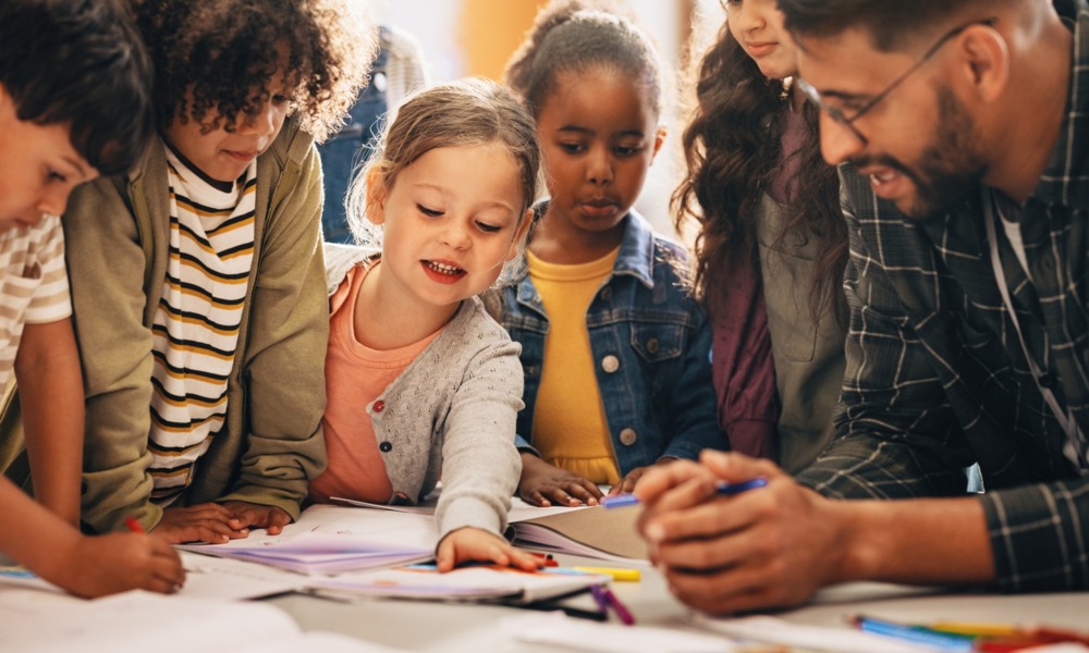 On youth program quality_feature2: group of young children learning excitedly around table
