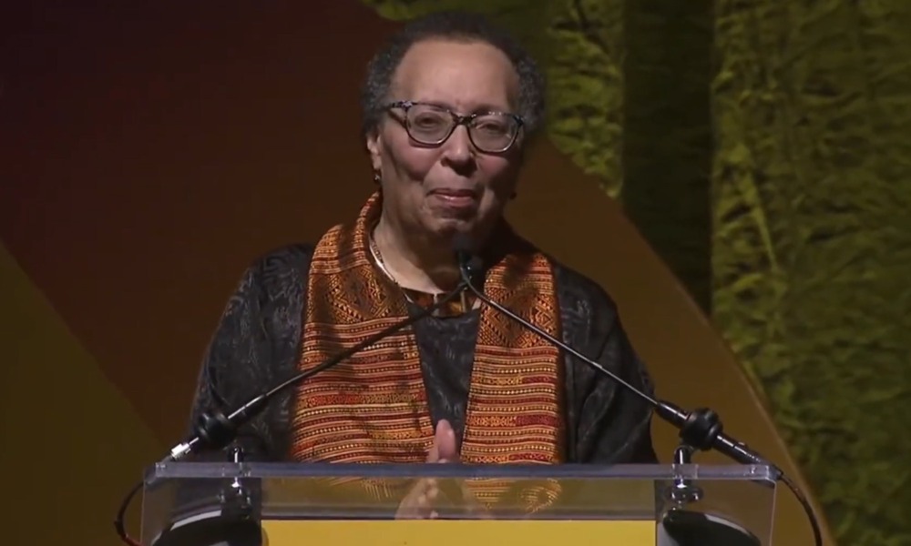 QA_ Karen Pittman _2026 NEA Foundation’s Outstanding Service Public Education Award_older black woman stand at podium with hands clasped in front of her