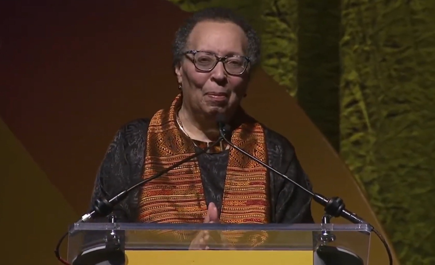 QA_ Karen Pittman _2026 NEA Foundation’s Outstanding Service Public Education Award_older black woman stand at podium with hands clasped in front of her