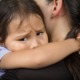 Child safety was never meant to look like this_feature: A sad little girl hugging her parent to feel safe, tearful.
