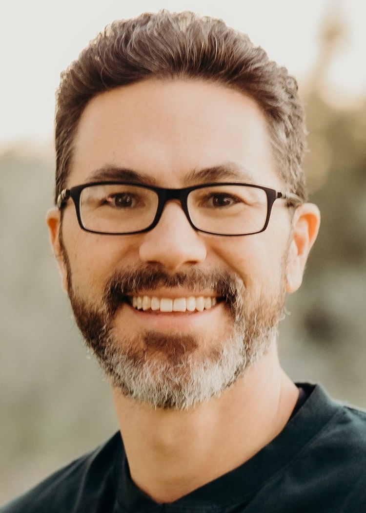 Jonathan Nakamoto headshot: white man with dark-rimmed glasses with brown hair and short graying beard