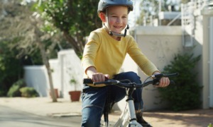youth cycling grants: Road, happy and child on bicycle in neighborhood for learning