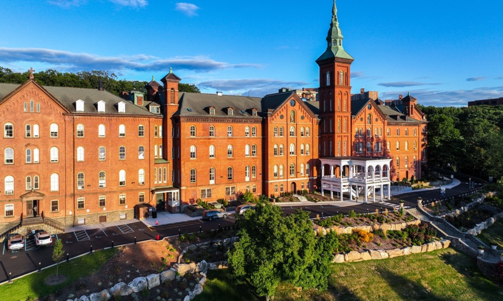 How a scholarship for homeless youth gave me the stability to build a future_feature: an old college building with tall tower on a nice day with clear, blue skies