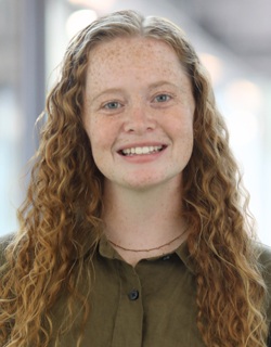 Lauren Hurley headshot: young white woman with long curly hair