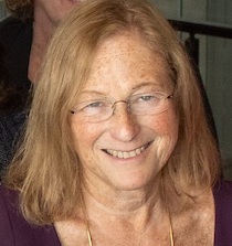Sandy Baum headshot: white woman with shoulder length hair and glasses in black shirt