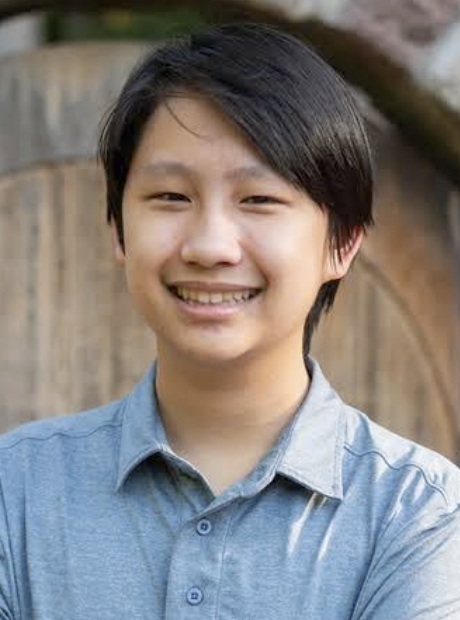Spencer Chaisanguanthum headshot: young asian male smiling outdoors in button-up blue shirt
