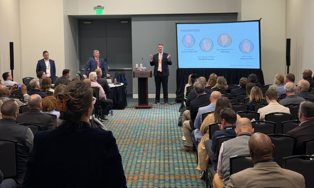 Strengthening school-afterschool partnership_Tips trends 2026 School Superintendents Conference_feature: man speaks and presents in front of room full of people with a screen to his left