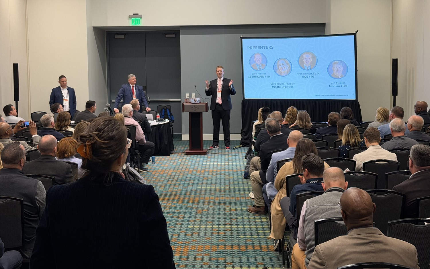 Strengthening school-afterschool partnership_Tips trends 2026 School Superintendents Conference_feature: man speaks and presents in front of room full of people with a screen to his left