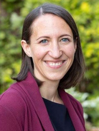 Ashley Boat headshot: white woman with medium-length brown hair smiling outdoors