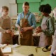 Social capital From participants to partners Rethinking the role of alumni in youth programs_feature: group of youth learning woodworking from young instructor