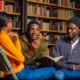 We're teaching skills but not purpose, meaning-making _The missing metric in youth development_feature: group of black youth discussing ideas in library setting while one holds a book open