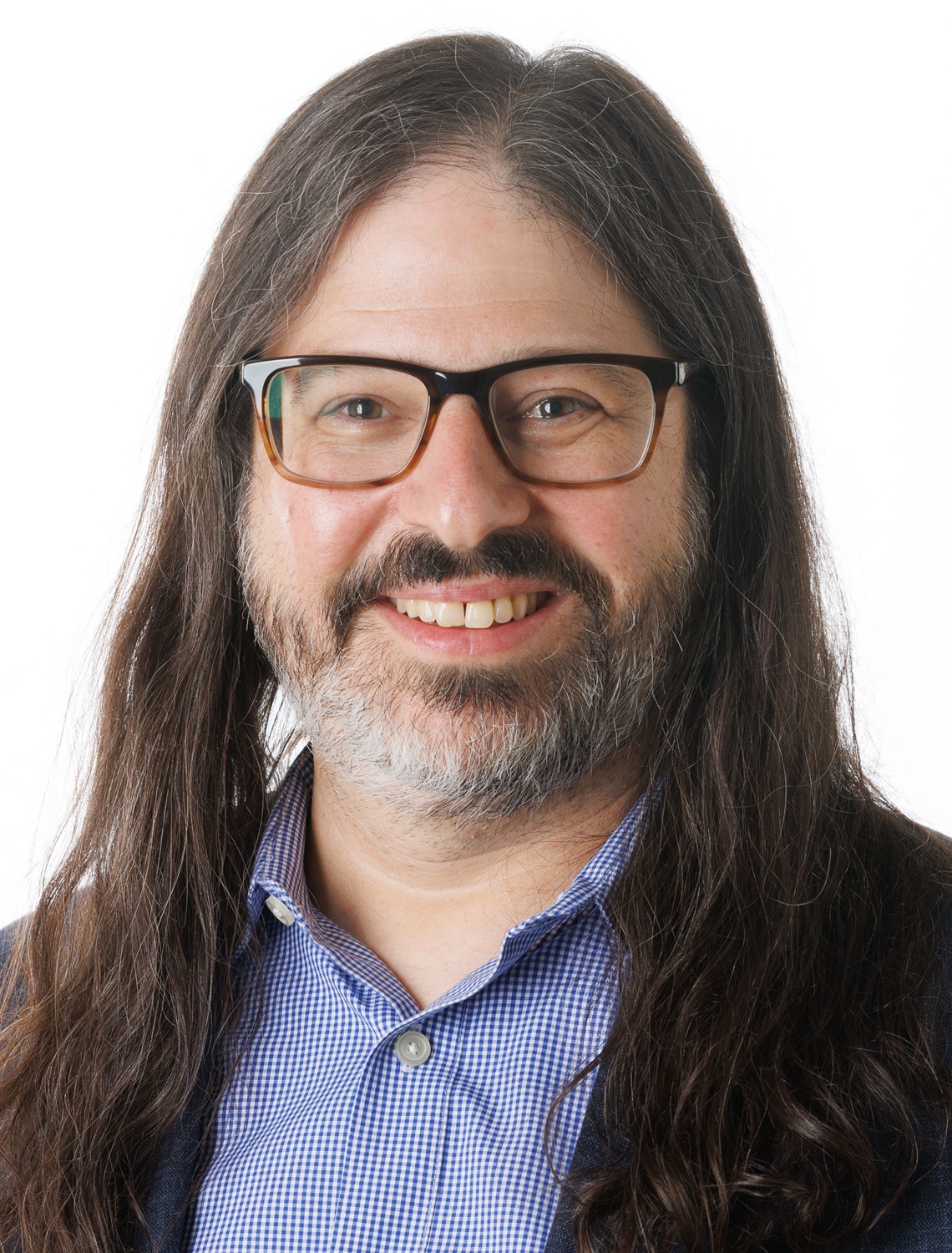 Marc Fernandes headshot: white man with long dark hair and greying beard in thick-rimmed glasses