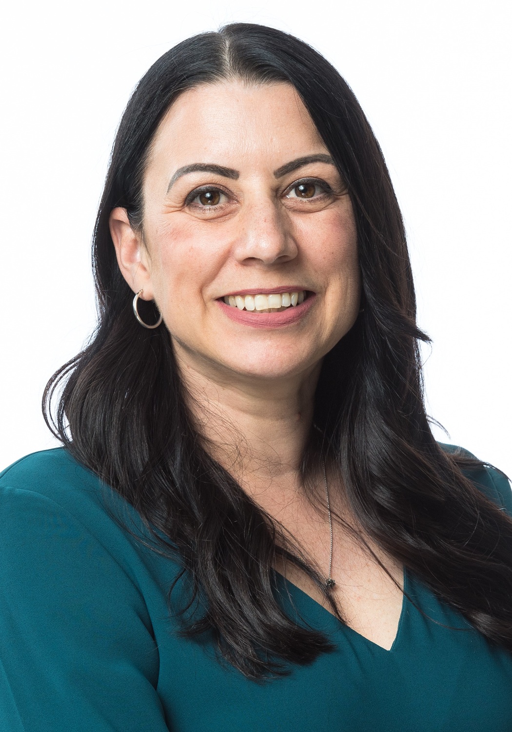 Sarah Veader headshot: white woman with long dark hair smiling in front of white background