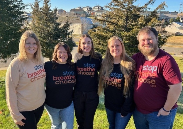 Supporting our direct care workforce isn't optional_group photo: group of people wearing matching shirts smiling outside