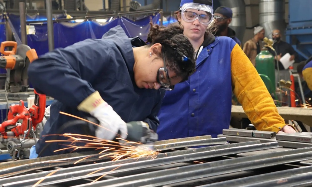 Why America must invest in apprenticeships — now_feature: a young metal working apprentice works in a metal shop