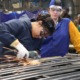 Why America must invest in apprenticeships — now_feature: a young metal working apprentice works in a metal shop