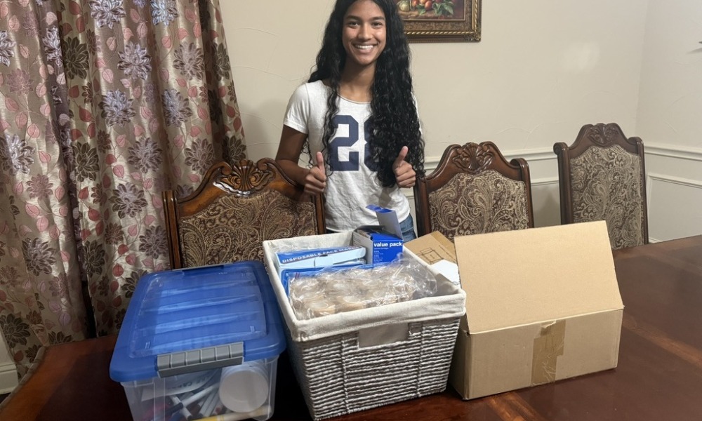 How Cureco is redefining youth-led health advocacy, youth-led advocacy_feature: teen girl with long dark hair stand in front of boxes of medical supplies on table