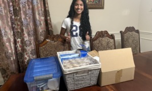 How Cureco is redefining youth-led health advocacy, youth-led advocacy_feature: teen girl with long dark hair stand in front of boxes of medical supplies on table