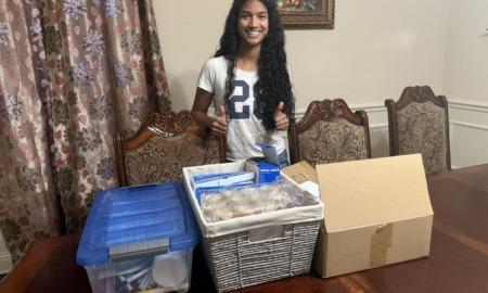 How Cureco is redefining youth-led health advocacy, youth-led advocacy_feature: teen girl with long dark hair stand in front of boxes of medical supplies on table