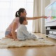 PreK-5 educational media development and dissemination grants_feature: a mother points to something on tv screen as young boy watches