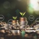 What is wealth-a teen perspective_feature2: graphic depicting money growing over time with piles of coins and seedlings sprouting, financial education