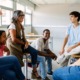 What kind of developmental environments help young people become fully human_feature: group of young people in classroom after hours talking to educator