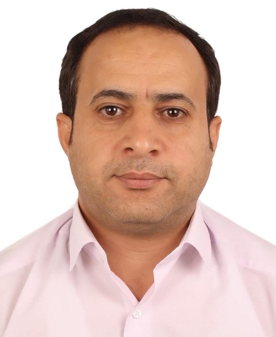 Abdullah Mohammed Kassim headshot: man with dark hair wearing white button up shirt in front of white background