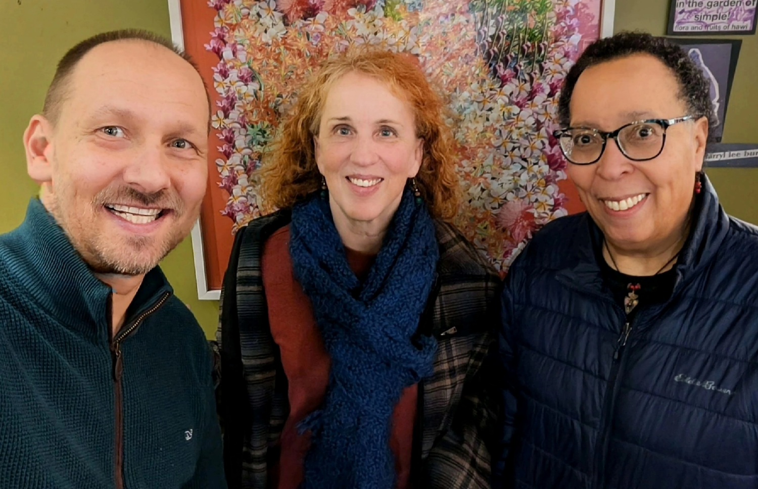 Exploring the trust gap-An open invitation_Busboys trio: selfie of a man and two women smiling in front of colorful wall art