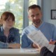 In and beyond the school day-Expanding access to the behavioral supports that shape young people’s futures_feature2: young red haired girl and father meet with education professional