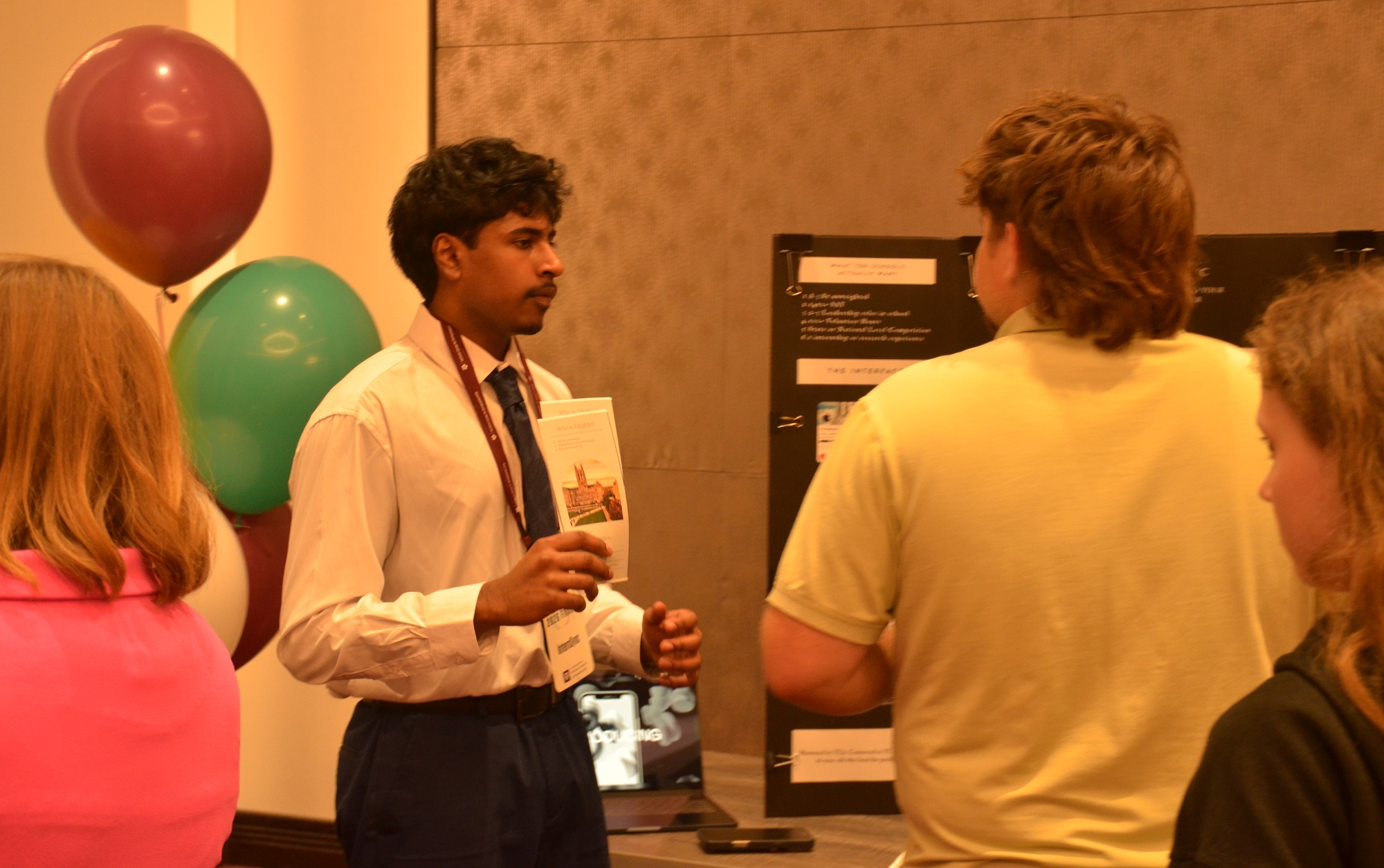 Q&A Shourya Kancharla, 16-year-old founder of Simple Minds Matter, youth mental health _feature: young man holding pamphlet at event