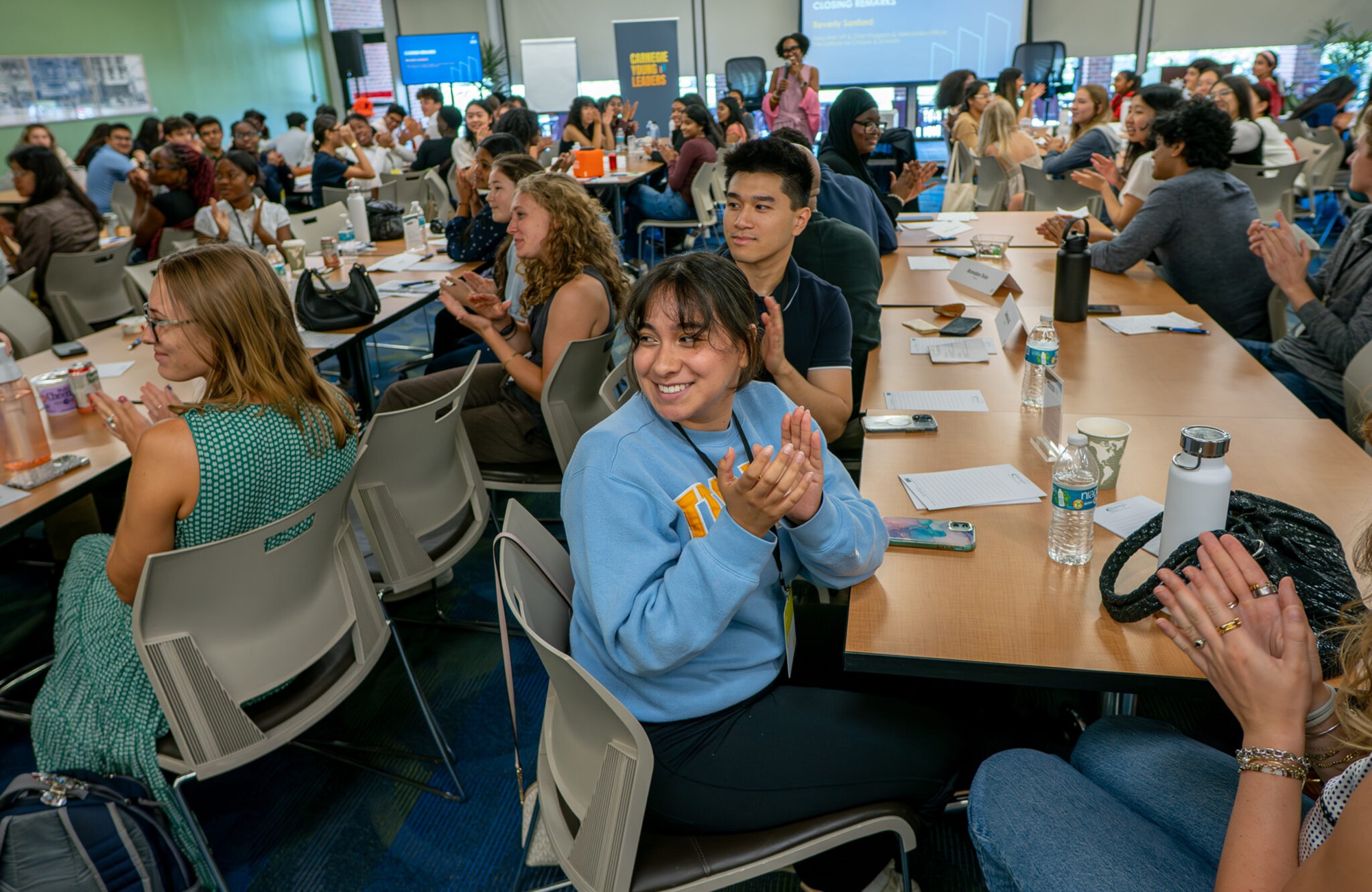When young people lead, communities change-Meet the new class of Carnegie Young Leaders_feature: large group of youths filling conference room smiling and clapping