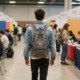 Why career readiness programs should treat teens as emerging adults_feature: a young male teen with backpack walks through a career fair
