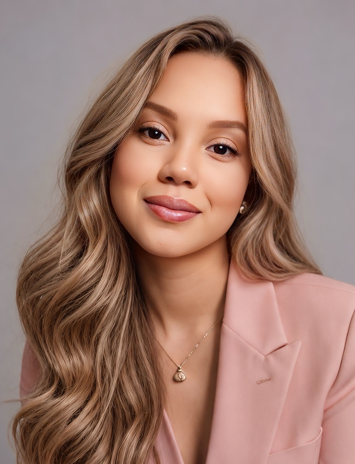 Channing L Collins headshot2: woman with long blonde hari wearing beige blazer and smiling