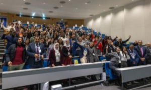 Global sustainability award grants for youth, universities, and organizations_feature: large group of happy people in presentation room