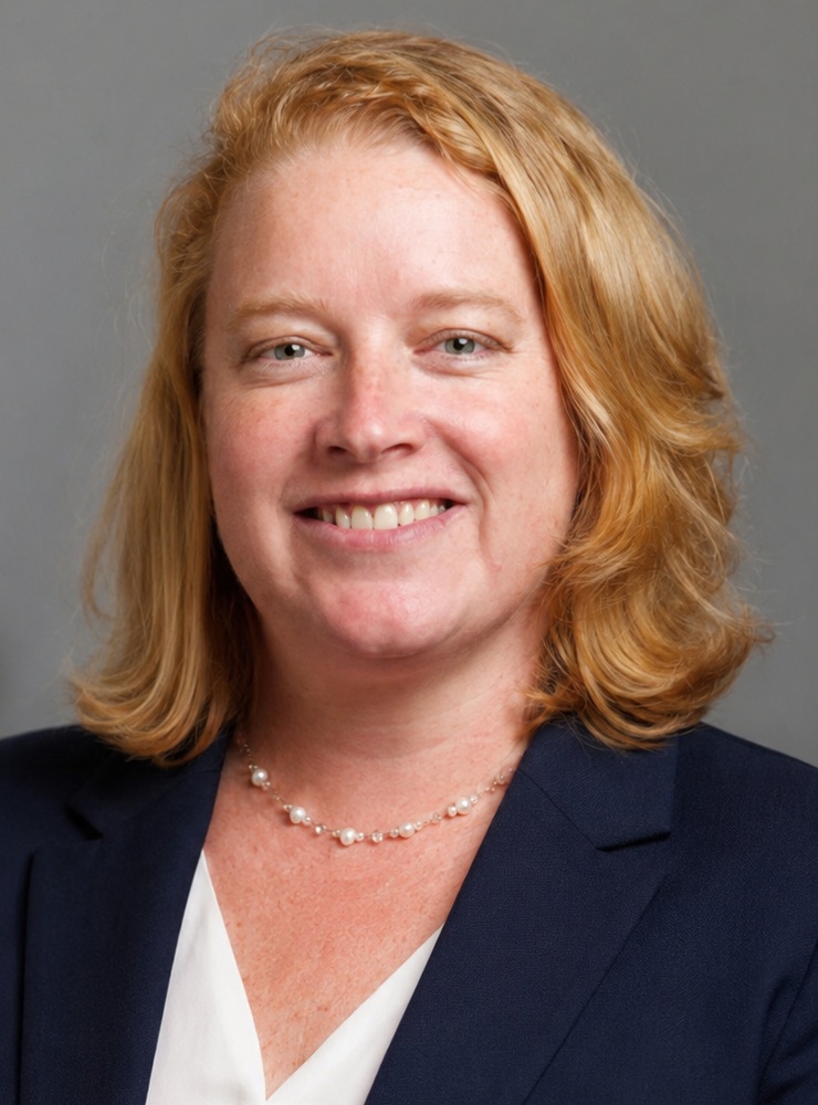 Kimberly Nolan headshot: white woman with medium length blonde hair wearing dark blazer and white shirt