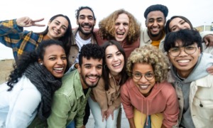 Latino community support grants: group of young multi-ethnic Latino youths smiling for camera