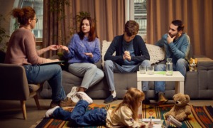 We're waiting too long to help kids in crisis — and leaving foster care as the only option_feature: a professional family behavioral health intervention specialist speaks with parents and teenage boy while young daughter draws while laying on floor