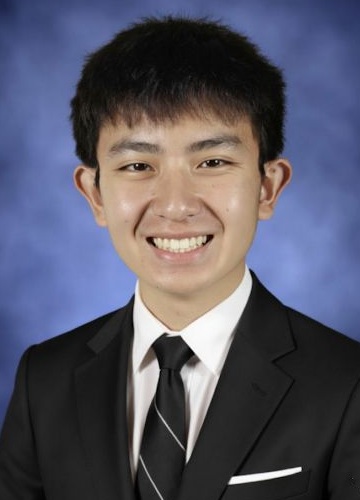 Daniel Zhang headshot: young Asian man with short dark hair wearing dark suite and tie against blue background
