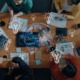 Educational leadership innovation grants: top-down view of group of people collaborating at table with lightbulb and globe graphics overlaid