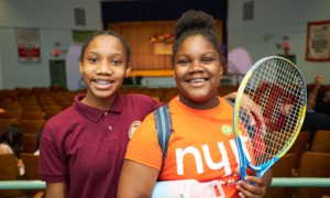 Quality afterschool is worth the investment — It changed my life_feature: two young black teens smile while one holds a tennis racket