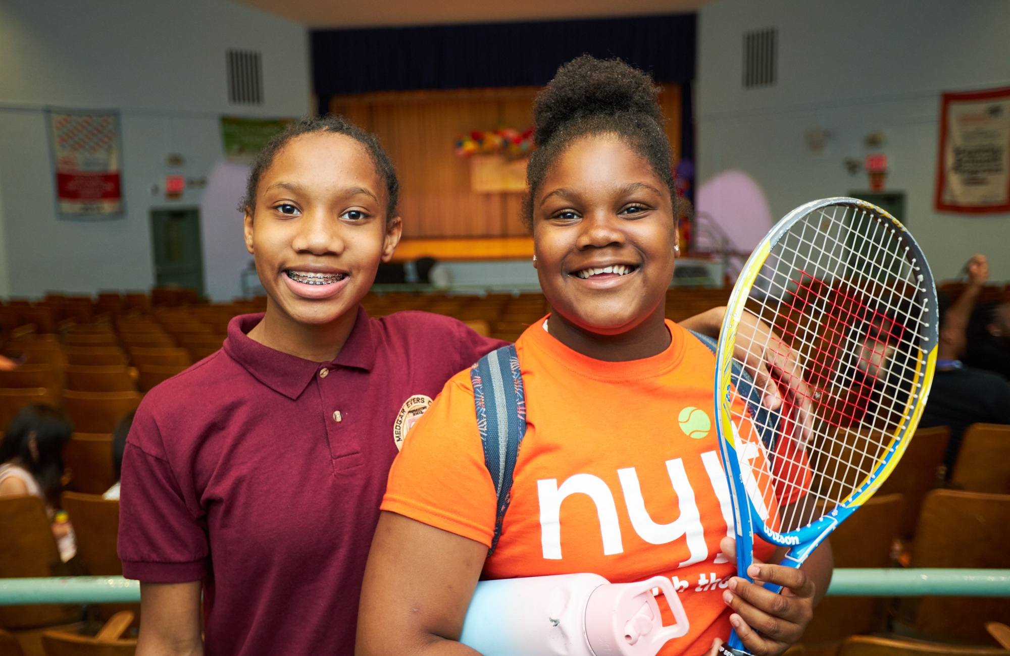 Quality afterschool is worth the investment — It changed my life_feature: two young black teens smile while one holds a tennis racket