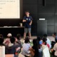 Students don’t just belong in STEAM classrooms-They belong at the front of them_feature: young Asian man stands at the front of a class full of young children teaching with powerpoint