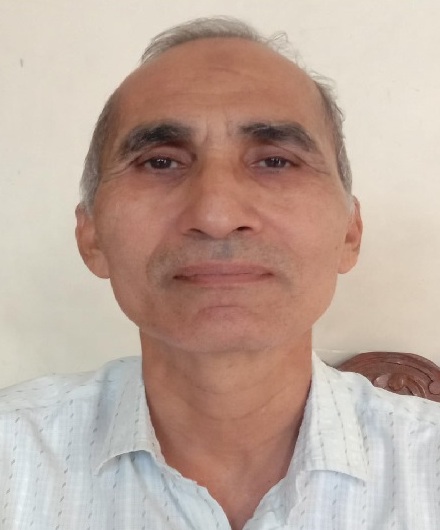 Umar Khalid headshot: middle-aged man in white collared shirt